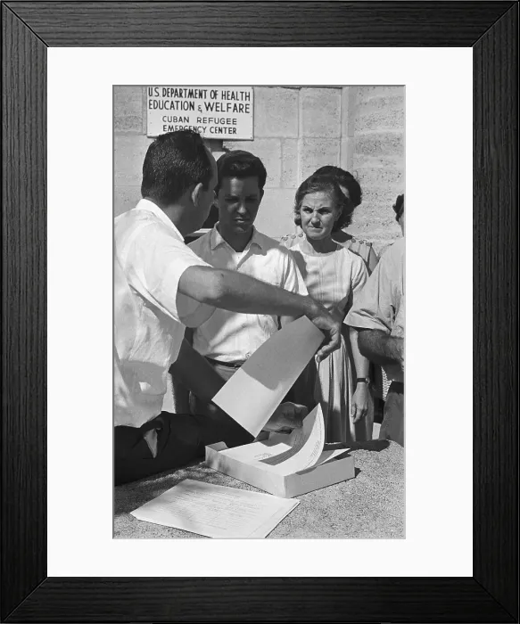 Framed Print : Refugees Looking over Forms Framed Print : Refugees Looking over Forms