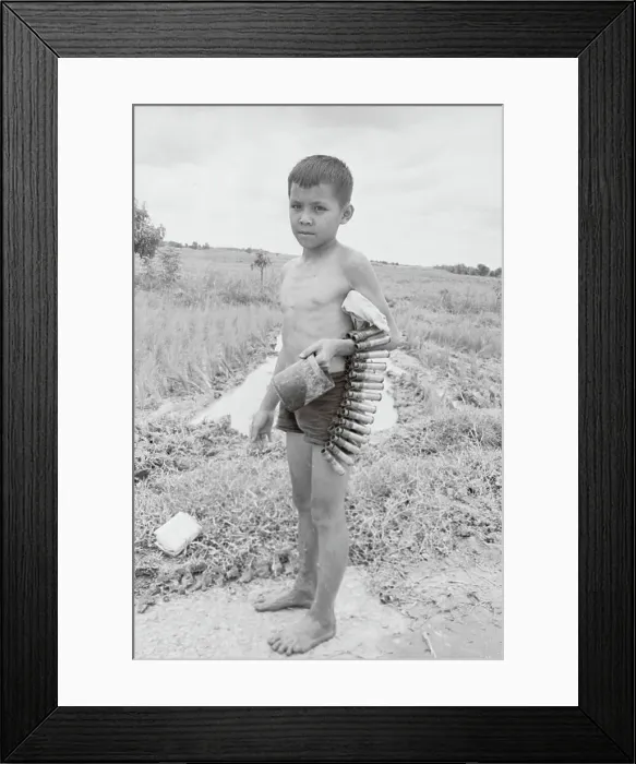 Framed Print : Young Vietnamese Boy Holding Bullet Belt Framed Print : Young Vietnamese Boy Holding Bullet Belt