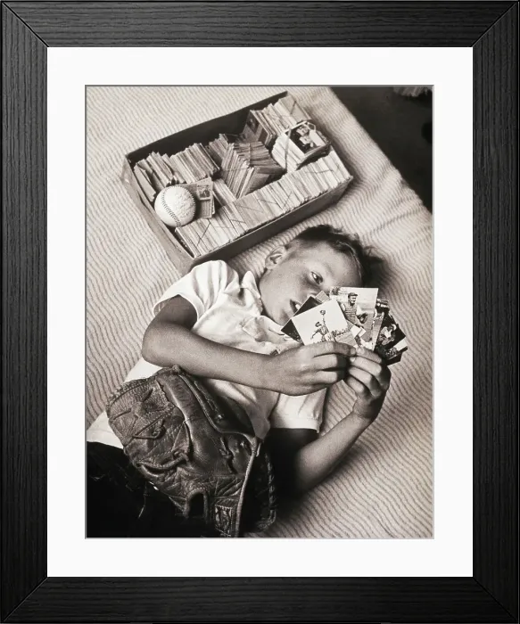 Framed Print : Boy Lying on Bed Studying Baseball Cards Framed Print : Boy Lying on Bed Studying Baseball Cards