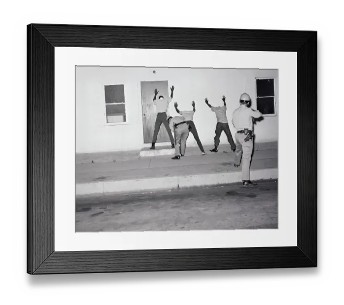 Framed Print : Police Searching Rioters Against Wall Framed Print : Police Searching Rioters Against Wall