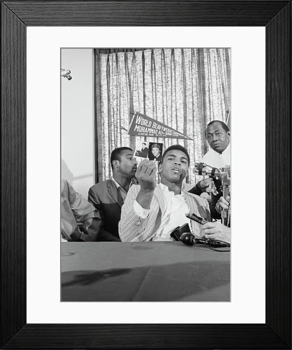 Framed Print : Cassius Clay Holding up Photos of Wallace Fard Muhammad Framed Print : Cassius Clay Holding up Photos of Wallace Fard Muhammad