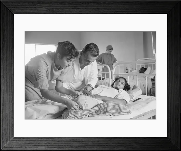 Framed Print : Peace Corp Nurse Attends to Patient with Amputated Leg Framed Print : Peace Corp Nurse Attends to Patient with Amputated Leg