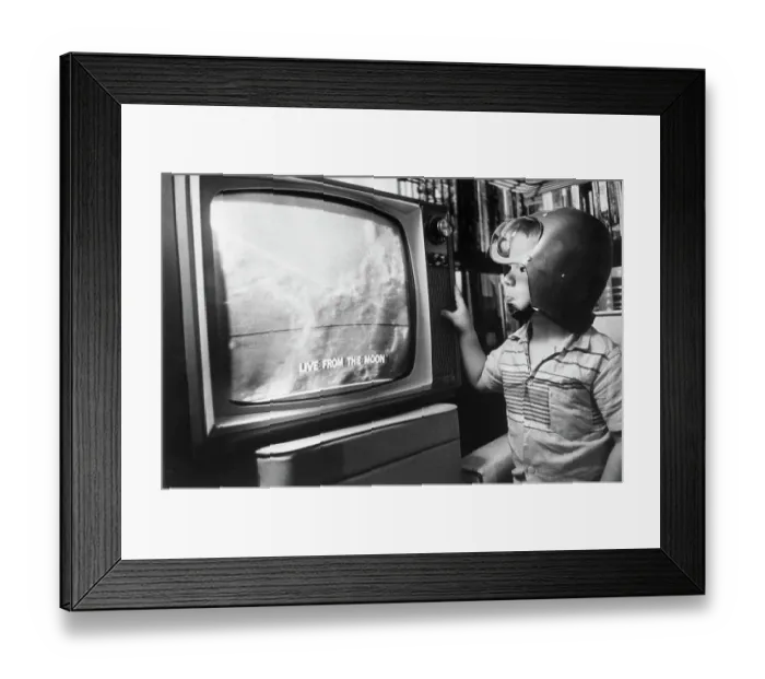 Framed Print : Boy with Space Helmet Watching Moon on Television Framed Print : Boy with Space Helmet Watching Moon on Television