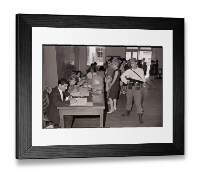 Framed Print : Armed Guard Watches Voters Cast Ballots