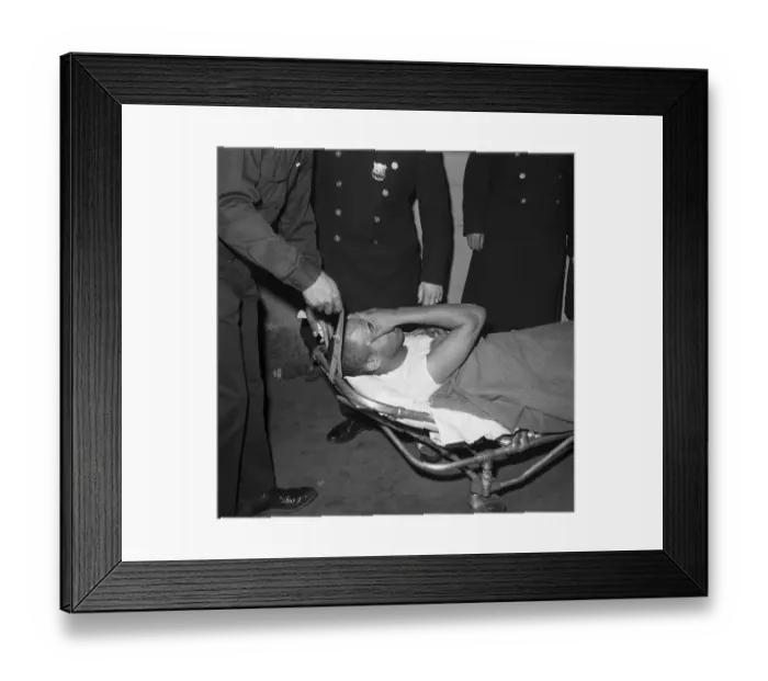 Framed Print : Thomas Hagan on Stretcher Covering Face Framed Print : Thomas Hagan on Stretcher Covering Face