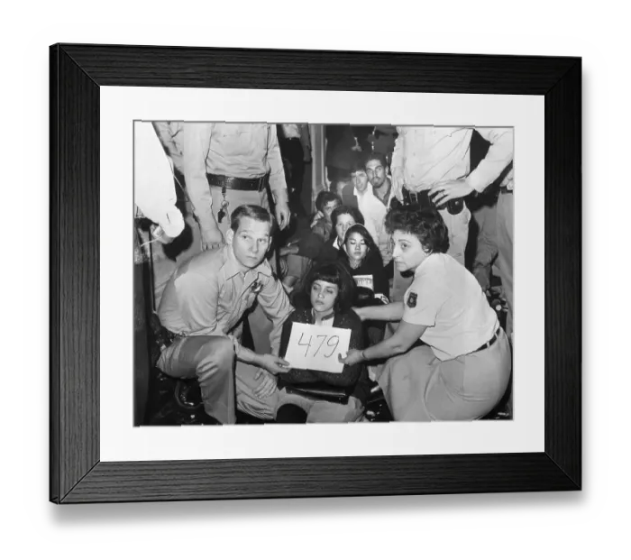 Framed Print : Police Hold Card Up to Seated Student Framed Print : Police Hold Card Up to Seated Student