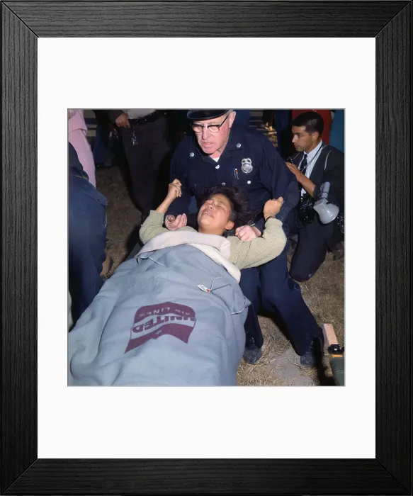 Framed Print : Policeman Assisting a Girl Who Fainted Framed Print : Policeman Assisting a Girl Who Fainted