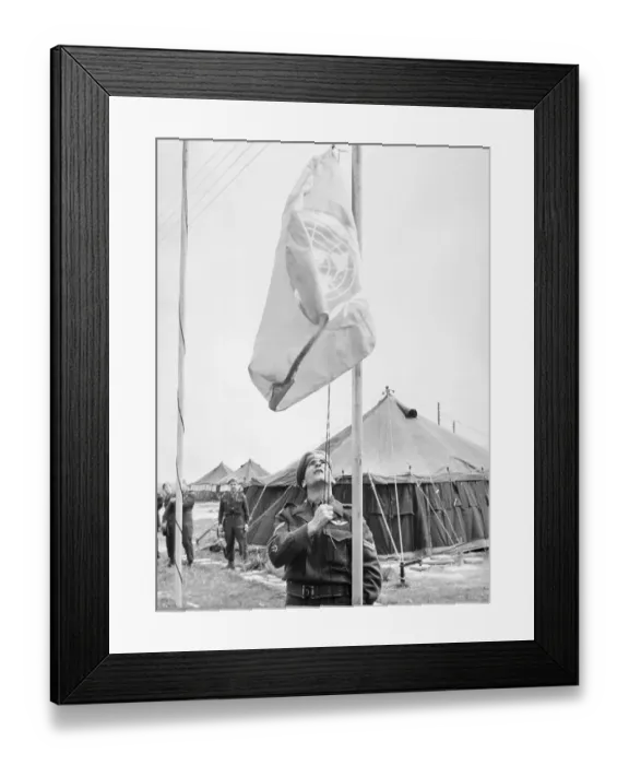 Framed Print : United Nations Soldier Raising Flag at Camp Framed Print : United Nations Soldier Raising Flag at Camp