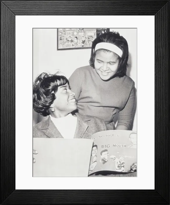 Framed Print : Sonny Liston's Daughters Happily Sharing Their Father's Scrapbook