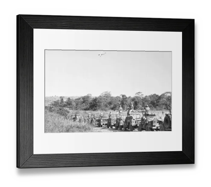 Framed Print : Airplane over Troops Traveling in Jeeps Framed Print : Airplane over Troops Traveling in Jeeps