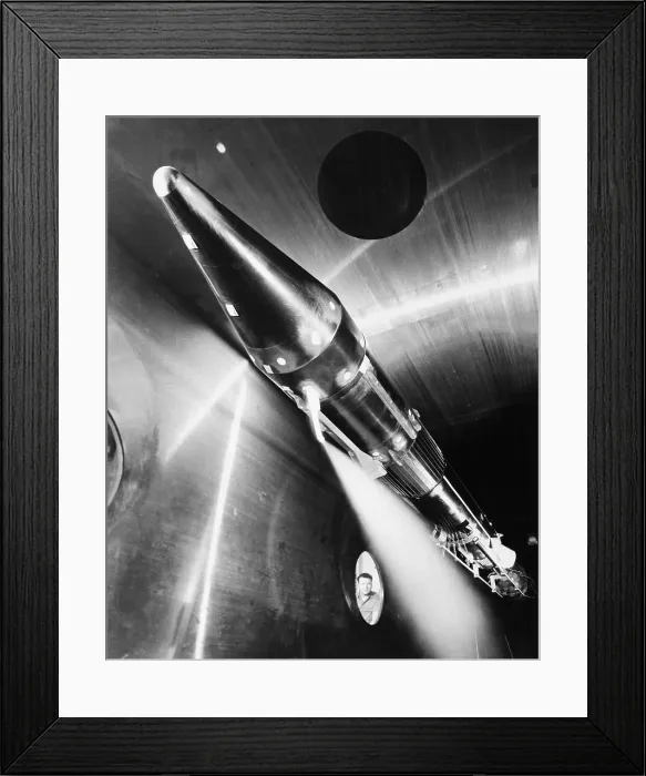 Framed Print : Man Looks Through Window at Rocket in Room Framed Print : Man Looks Through Window at Rocket in Room