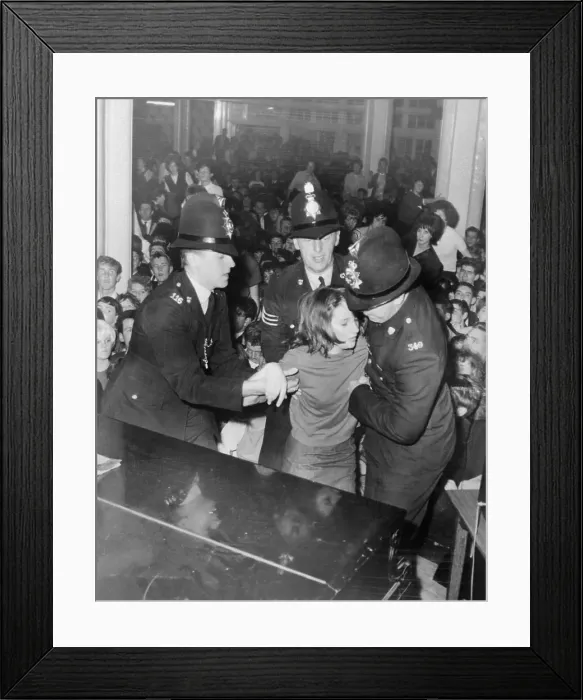 Framed Print : Policemen Helping a Fainting Beatles fan Framed Print : Policemen Helping a Fainting Beatles fan