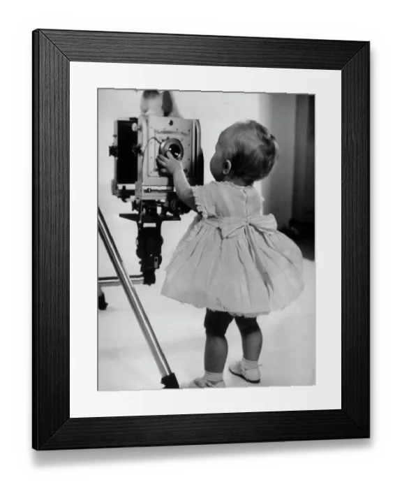 Framed Print : Two-Year-Old Girl Inspects Camera Lens Framed Print : Two-Year-Old Girl Inspects Camera Lens