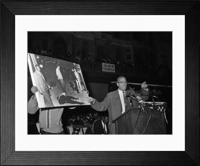 Framed Print : Malcolm X. Black Muslim minister Malcolm X has assistant hold picture of Framed Print : Malcolm X. Black Muslim minister Malcolm X has assistant hold picture of