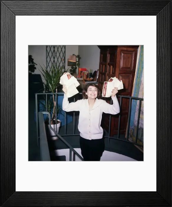 Framed Print : Anne Bancroft Holding Documents and Smiling