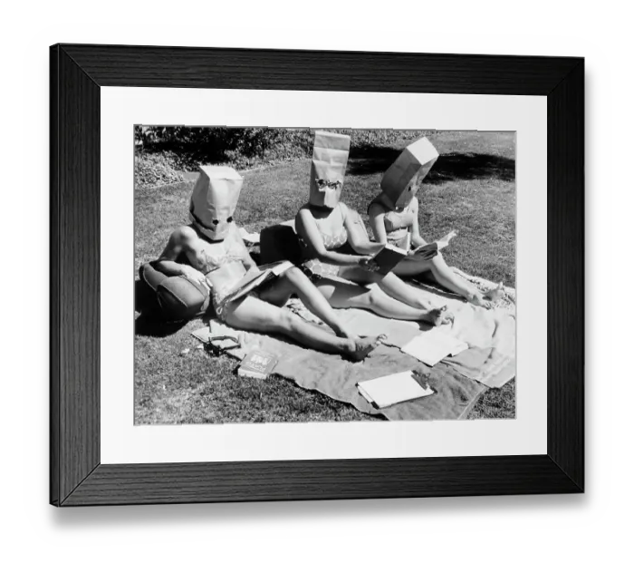 Framed Print : Girls Sunbathing with Paper Bags on Heads Framed Print : Girls Sunbathing with Paper Bags on Heads