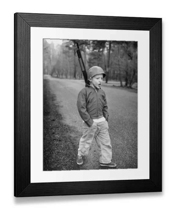Framed Print : Boy Dressed in Military Wear and Mimicking a Soldier