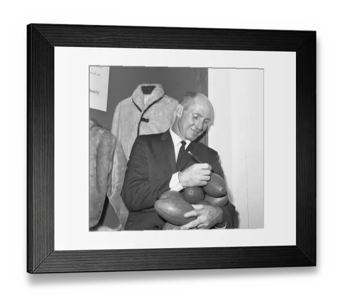 Framed Print : Star Football Player Autographing Footballs