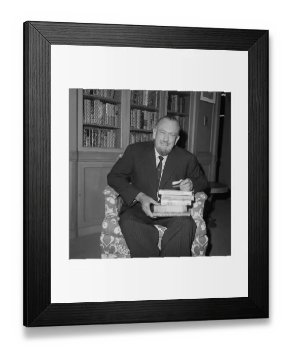 Framed Print : John Steinbeck Sitting and Holding Stack of Books Framed Print : John Steinbeck Sitting and Holding Stack of Books