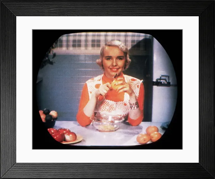 Framed Print : Woman Peeling Oranges on TV Framed Print : Woman Peeling Oranges on TV