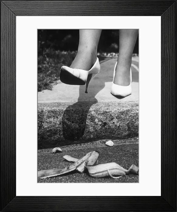 Framed Print : Woman in Heels Stepping on Banana Peel Framed Print : Woman in Heels Stepping on Banana Peel