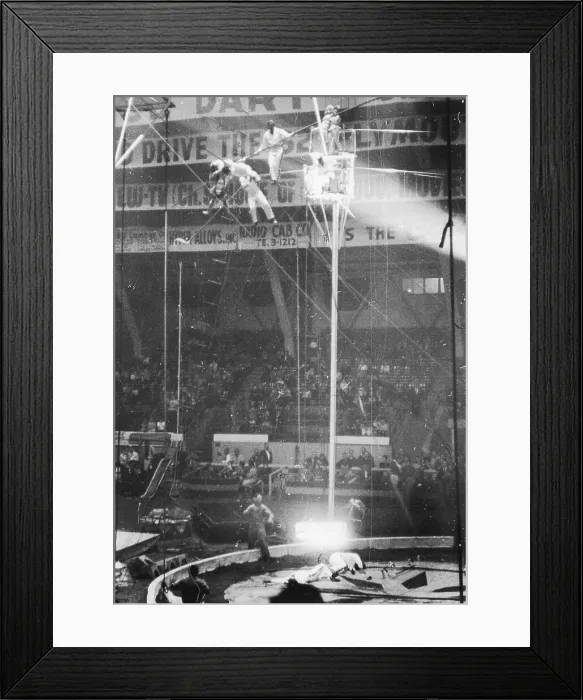 Framed Print : Wallendas. Two of the Flying Wallendas lie on the floor as other members Framed Print : Wallendas. Two of the Flying Wallendas lie on the floor as other members