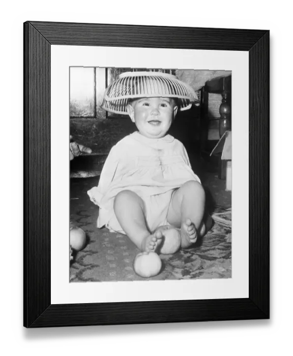 Framed Print : Young Infant Child Wearing Basket on his Head Framed Print : Young Infant Child Wearing Basket on his Head