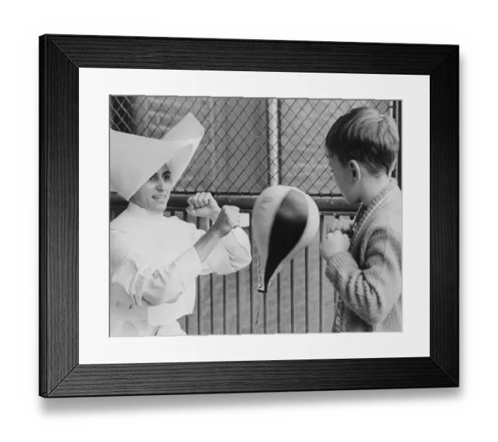 Framed Print : Nun Teaching Young Boy to Box Framed Print : Nun Teaching Young Boy to Box