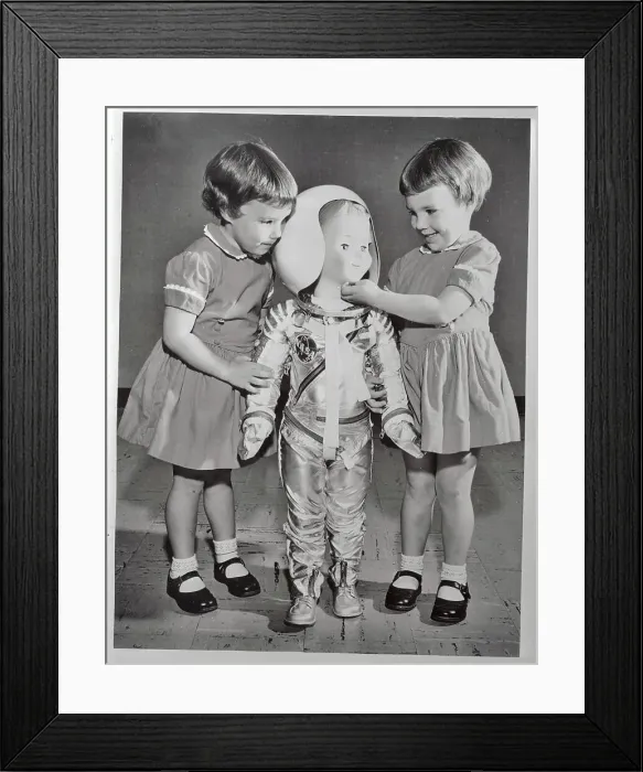 Framed Print : Twin Girls Playing with Astronaut Doll Framed Print : Twin Girls Playing with Astronaut Doll