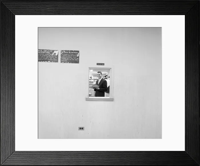 Framed Print : Pharmacy Director Standing in Window Framed Print : Pharmacy Director Standing in Window