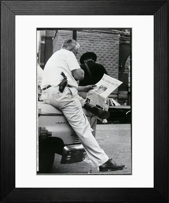 Framed Print : Police Officer Reading Newspaper Framed Print : Police Officer Reading Newspaper