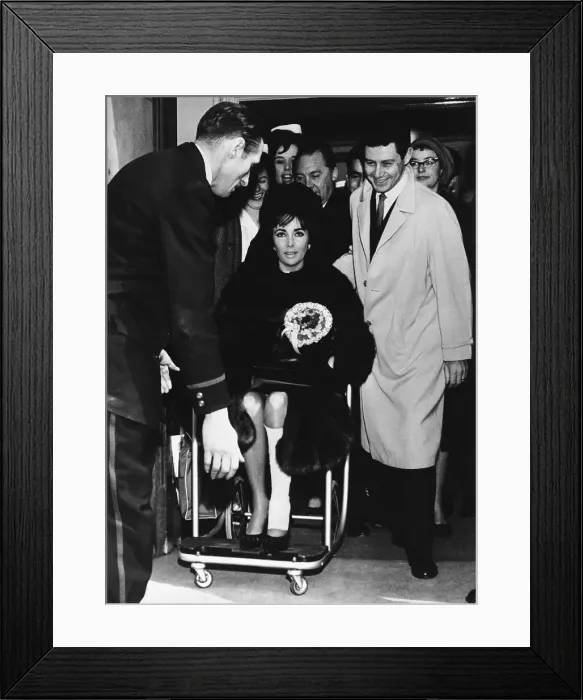 Framed Print : Liz Taylor Being Pushed in Wheelchair Framed Print : Liz Taylor Being Pushed in Wheelchair
