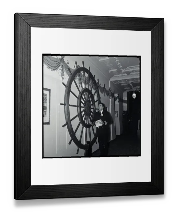 Framed Print : Otto Graham Admiring Ship Wheel on Wall Framed Print : Otto Graham Admiring Ship Wheel on Wall