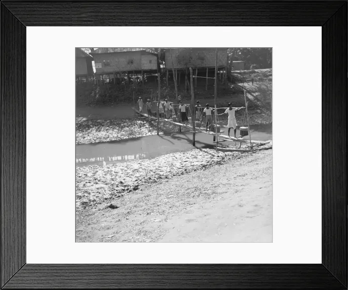 Framed Print : Farmer Crossing Makeshift Bridge over River Framed Print : Farmer Crossing Makeshift Bridge over River