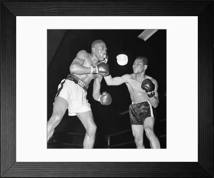 Framed Print : Boxer Takes Hard Right Punch From Oppone