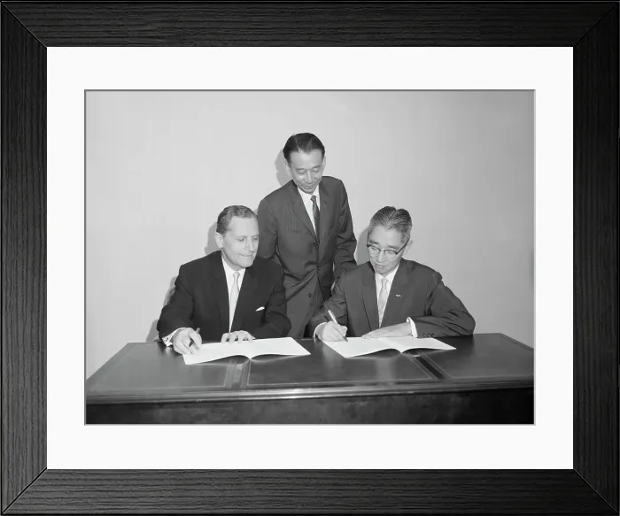 Framed Print : Sony Executive Signing Stock Documents Framed Print : Sony Executive Signing Stock Documents