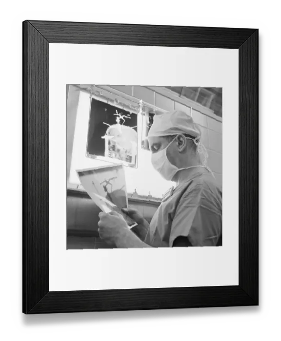 Framed Print : Surgeon Reading X-Ray Framed Print : Surgeon Reading X-Ray