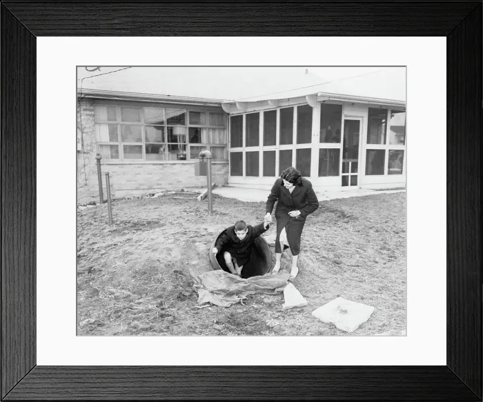 Framed Print : Family Emerging from Bomb Shelter Framed Print : Family Emerging from Bomb Shelter