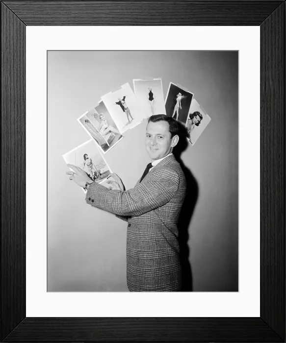 Framed Print : Tony Randall Pointing to Pictures of Actresses