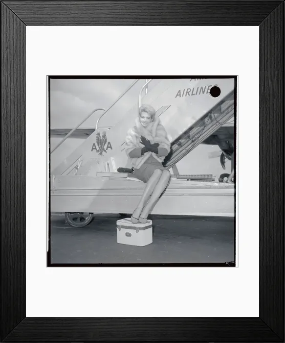 Framed Print : Angie Dickinson Sitting at Base of Airplane Steps