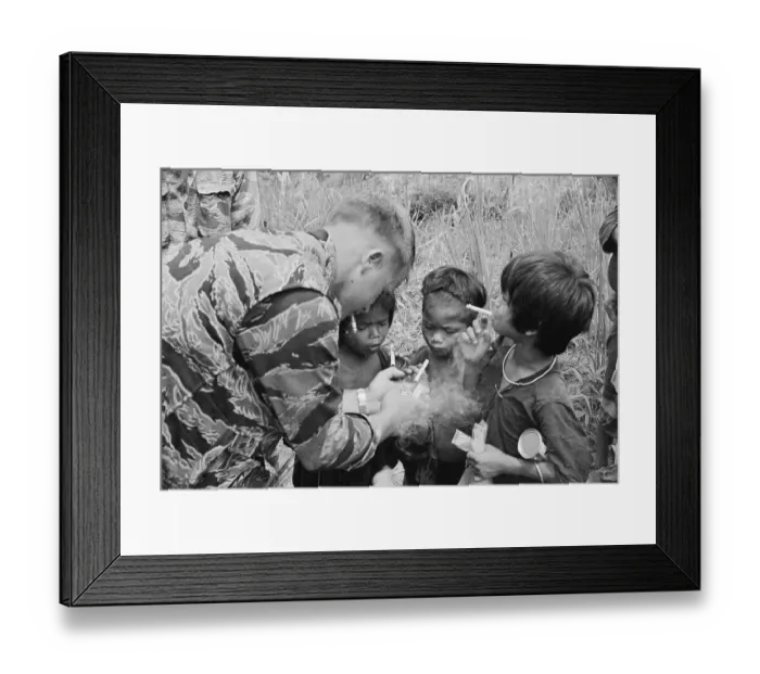 Framed Print : American Soldier Lighting Cigarettes for Montagnard Children Framed Print : American Soldier Lighting Cigarettes for Montagnard Children