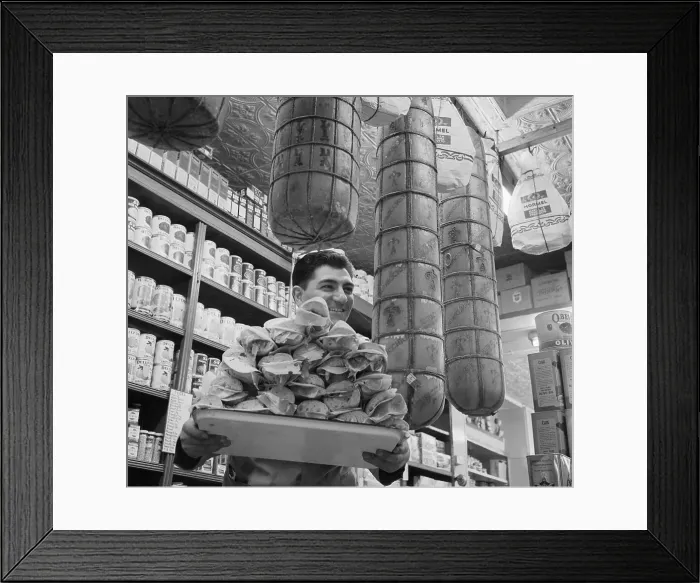 Framed Print : Man Carrying Hero Sandwiches Below Large Cheeses Framed Print : Man Carrying Hero Sandwiches Below Large Cheeses