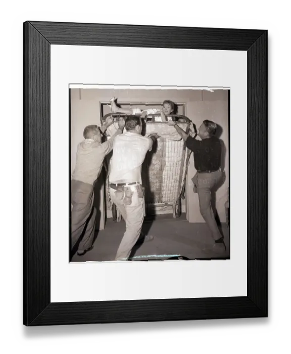 Framed Print : Crew Helps Debbie Reynolds out of Folding Bed Framed Print : Crew Helps Debbie Reynolds out of Folding Bed
