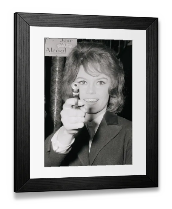 Framed Print : Brigitte Bardot Holding a Gun Framed Print : Brigitte Bardot Holding a Gun