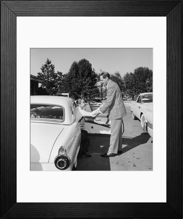 Framed Print : Mel Ferrer Helping Audrey Hepburn Out of Car