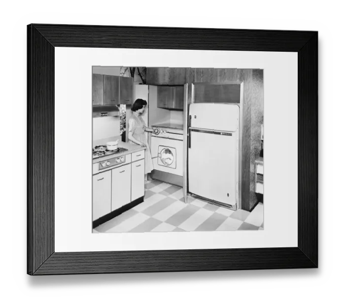 Framed Print : A Woman Using A Combination Washer Dryer