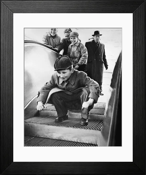 Framed Print : Child Crouching on Escalator Framed Print : Child Crouching on Escalator