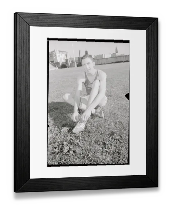 Framed Print : Don Bowden Sitting on Ground and Adjusting His Shoes Framed Print : Don Bowden Sitting on Ground and Adjusting His Shoes