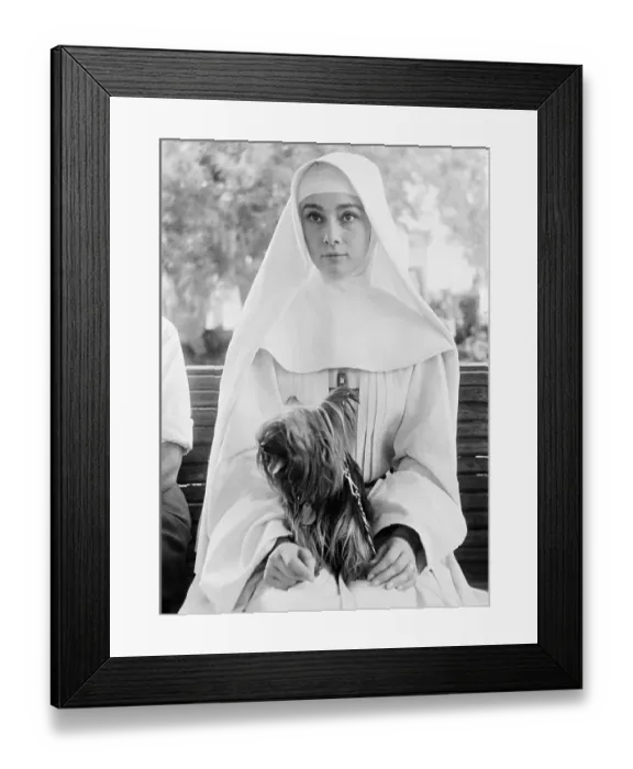 Framed Print : Audrey Hepburn in Costume Holding Her Dog Framed Print : Audrey Hepburn in Costume Holding Her Dog
