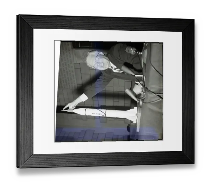 Framed Print : Man Pointing To Top Of Missile Model Framed Print : Man Pointing To Top Of Missile Model